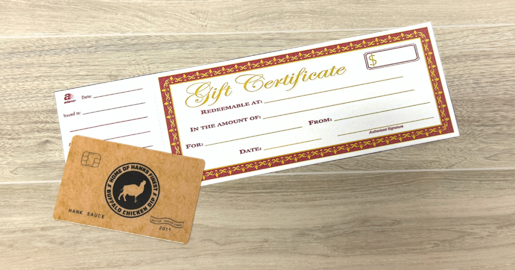Paper gift certificate displayed next to a branded plastic gift card, illustrating the transition from traditional gift certificates to modern gift card programs.
