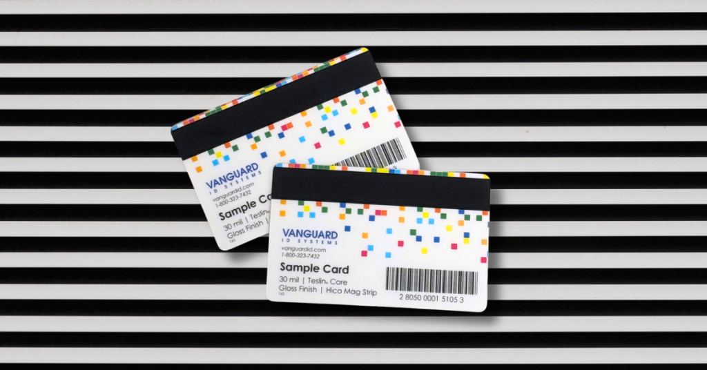 Two Vanguard ID sample cards with a barcode and magstripe on top of a striped background.